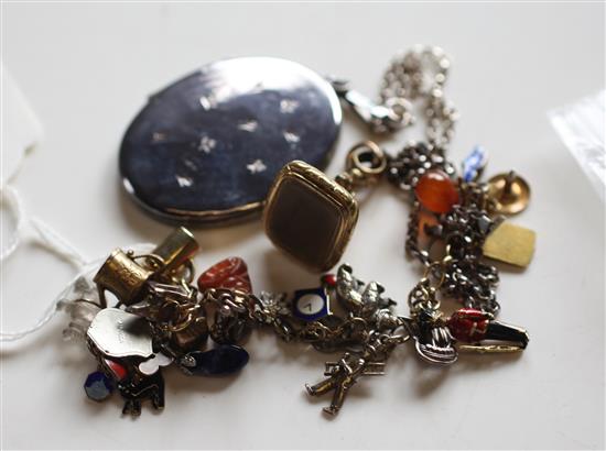 Charm bracelet hung with various gold, silver and enamel charms, silver enclosed locket & a gilt metal fob